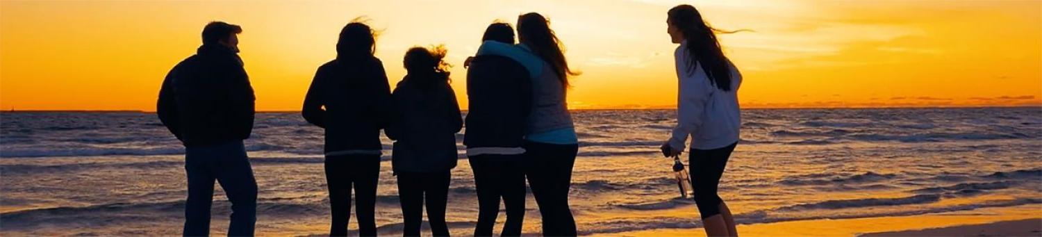 Students at beach at sunset