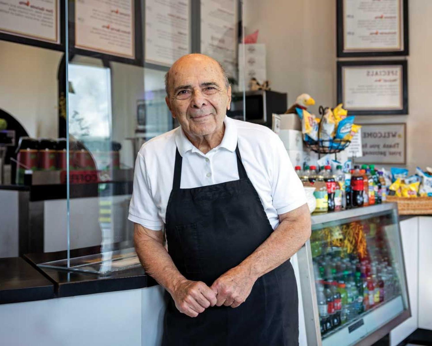 Photo of 约翰Acampora at the counter of his Flat Breads shop