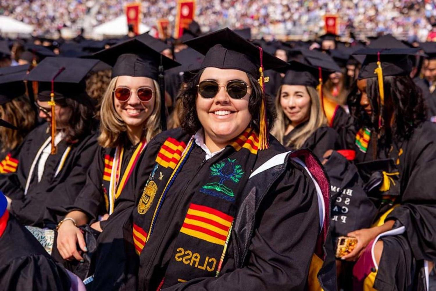 A group of students wearing caps and gowns at commencement