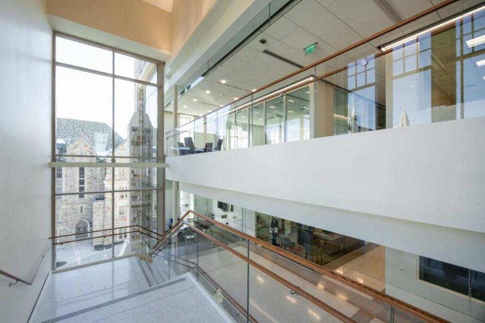 The sunlit main staircase offers views of campus.