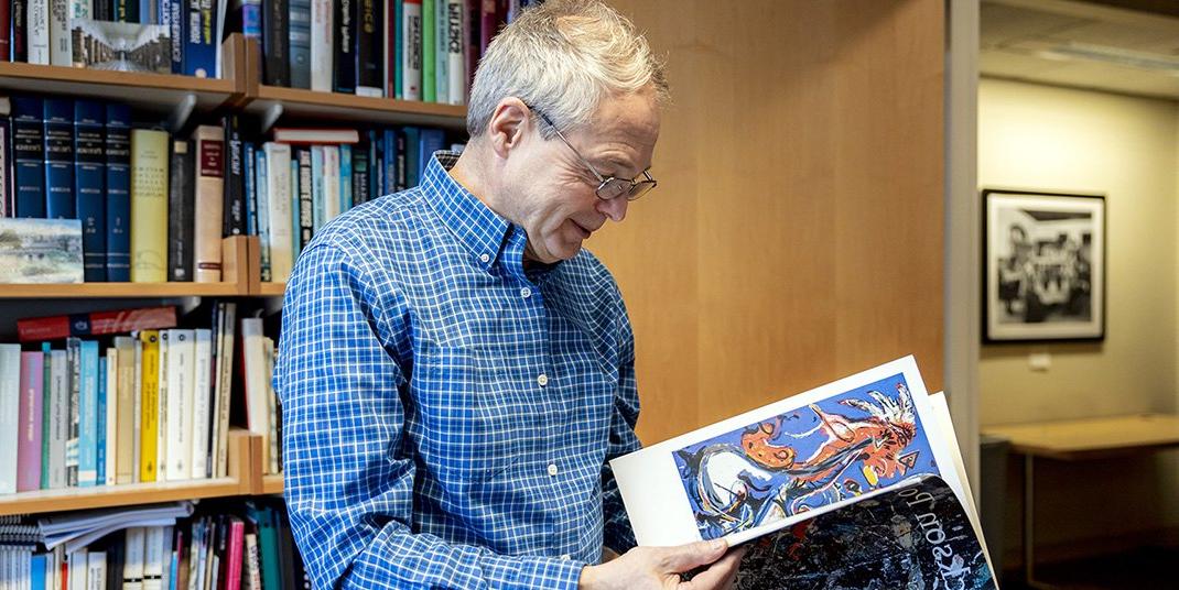 Andrzej Herczynski holding a booklet